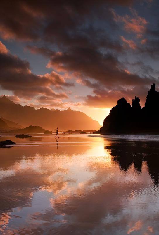 Sunlit beach and volcanic landscape in the Canary Islands - warm winter escape in January.