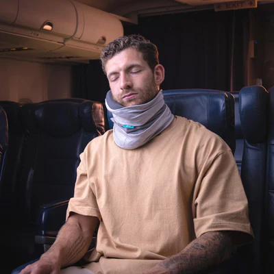 Trtl Travel Pillow Plus with ergonomic design for neck support during long flights.