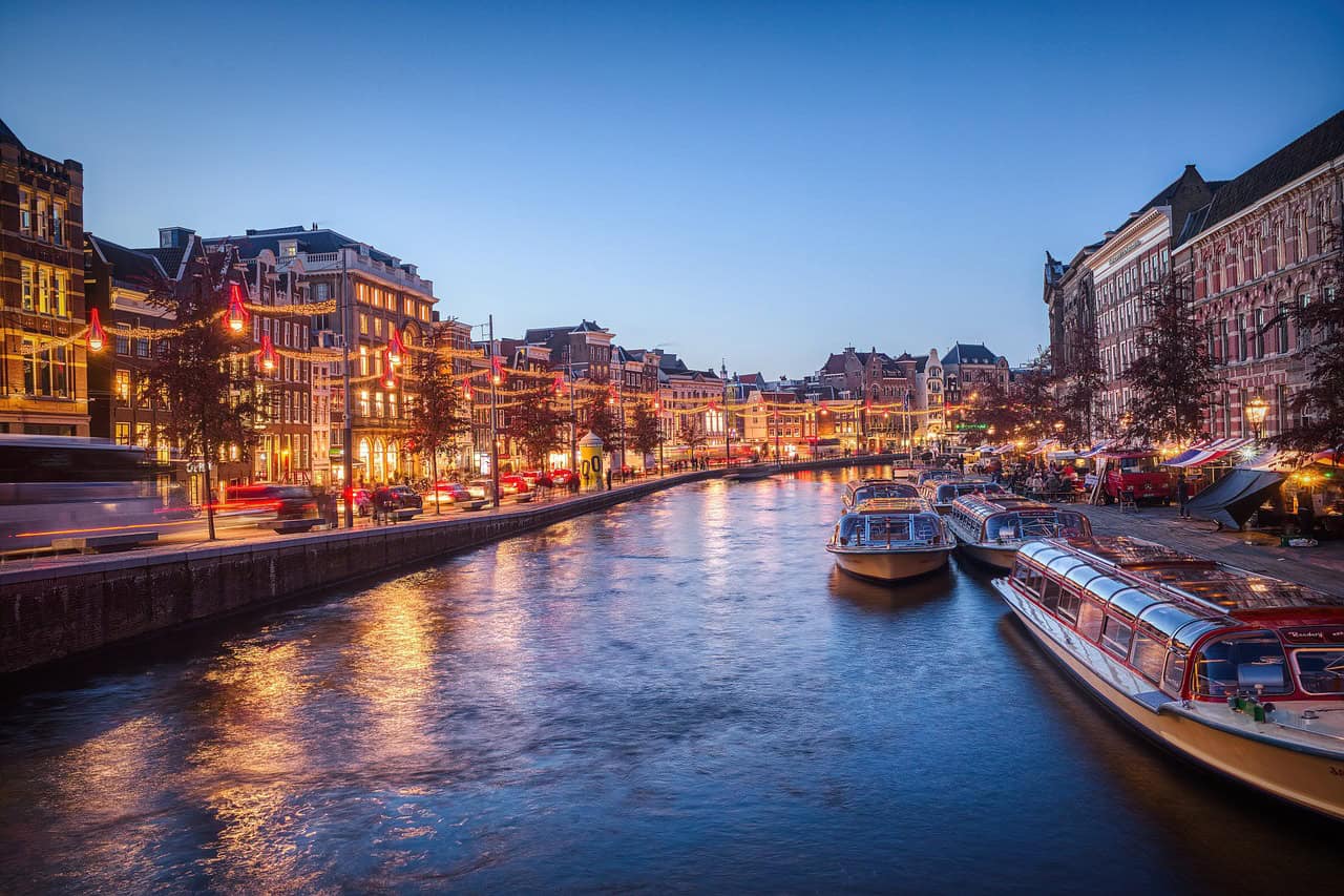 Scenic view of Amsterdam canals and historic buildings, showcasing the charm of the city.