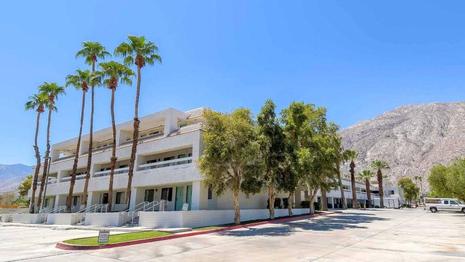 Motel 6 Palm Springs Downtown exterior with pool and mountain backdrop