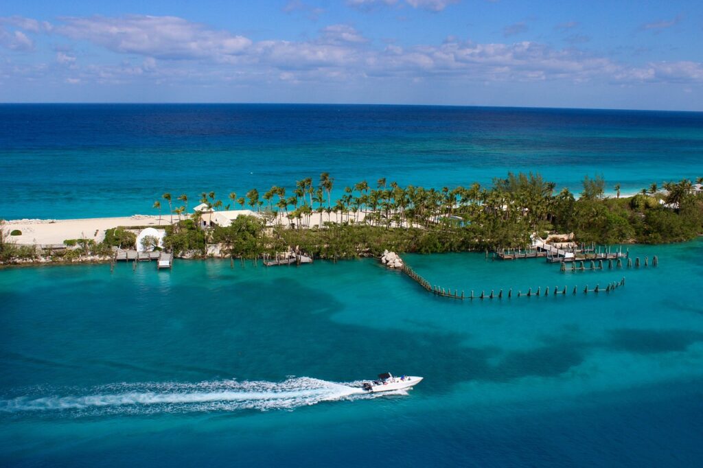 Crystal-clear blue waters of Exuma Cays in the Bahamas, known for swimming with pigs and stunning cays.