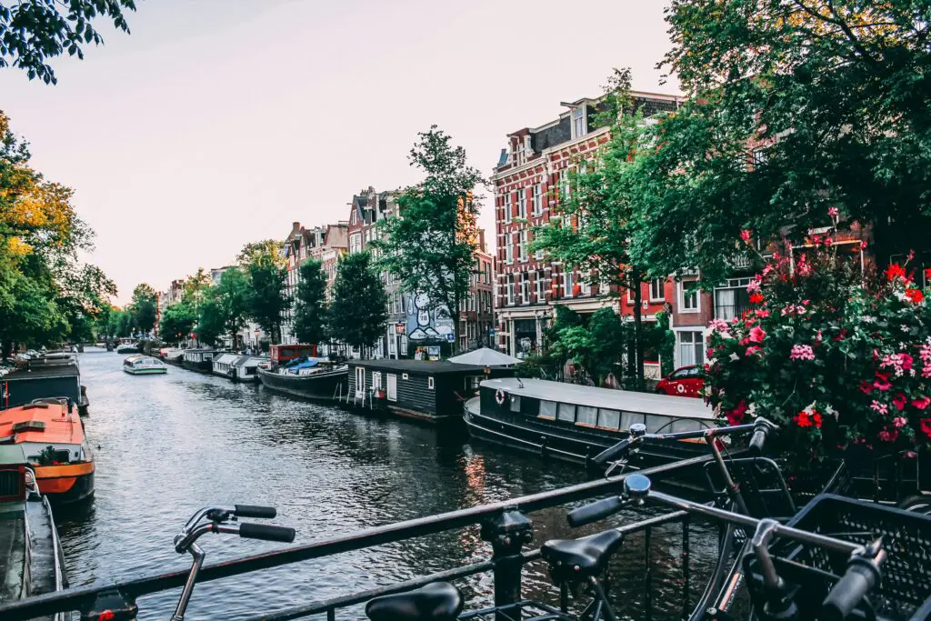 Amsterdam canal with boats and historic houses along the waterfront