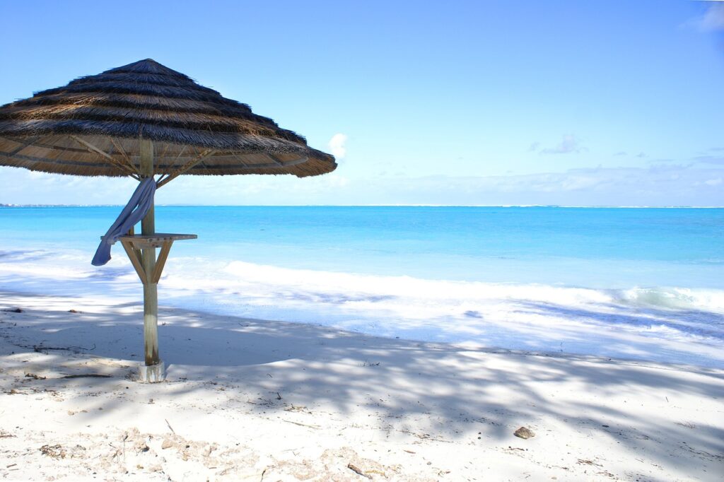 Soft white sands and turquoise waters of Grace Bay Beach in Turks and Caicos, a top destination for beach lovers.