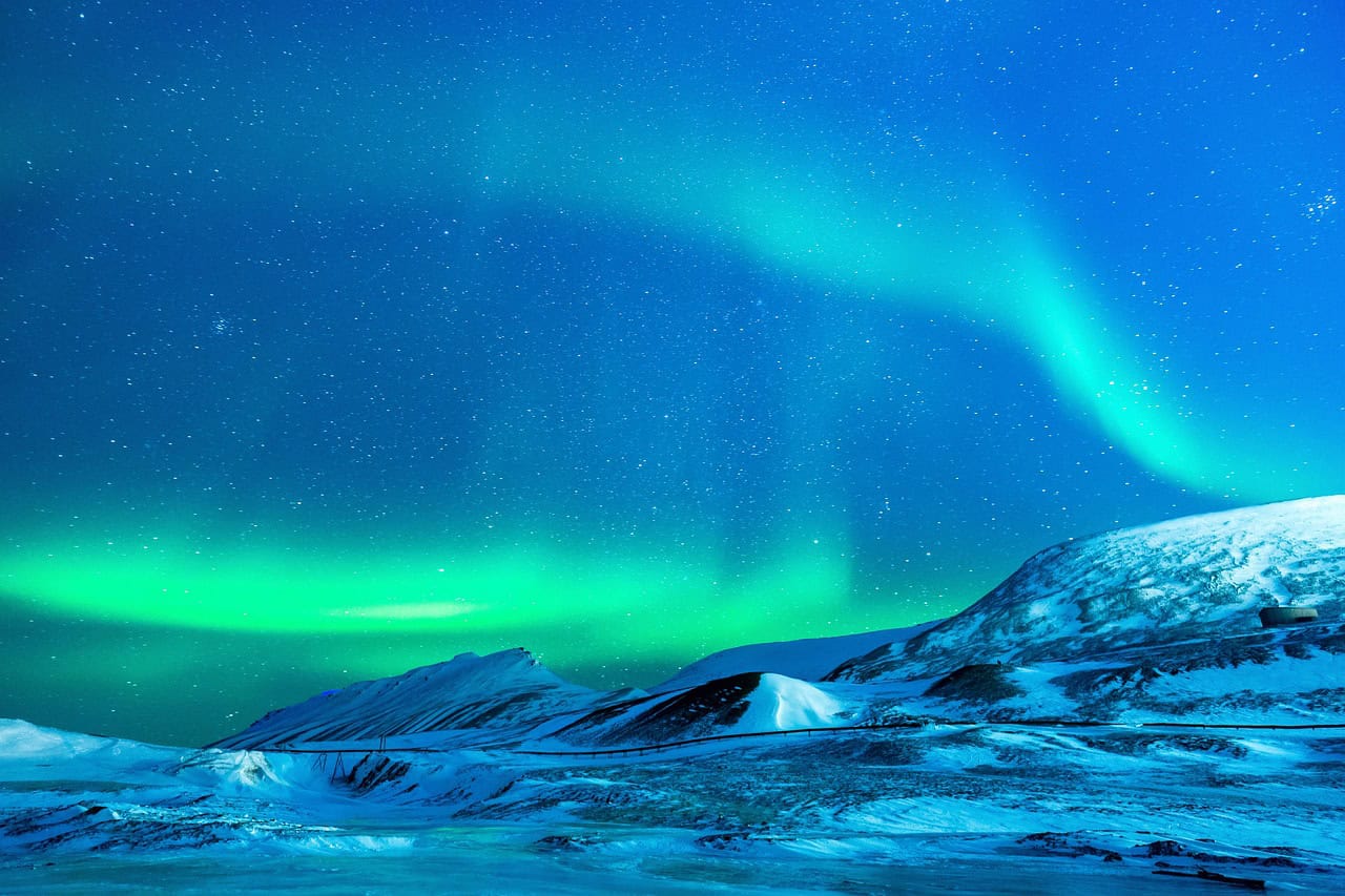 Northern Lights over snow-covered mountains in California