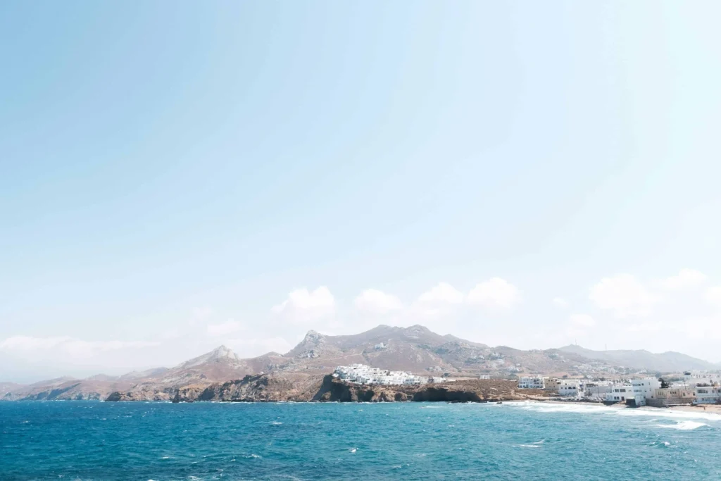 Coastal view of Naxos Island, one of the best honeymoon destinations in all-inclusive Greece, showcasing serene waters and traditional whitewashed architecture