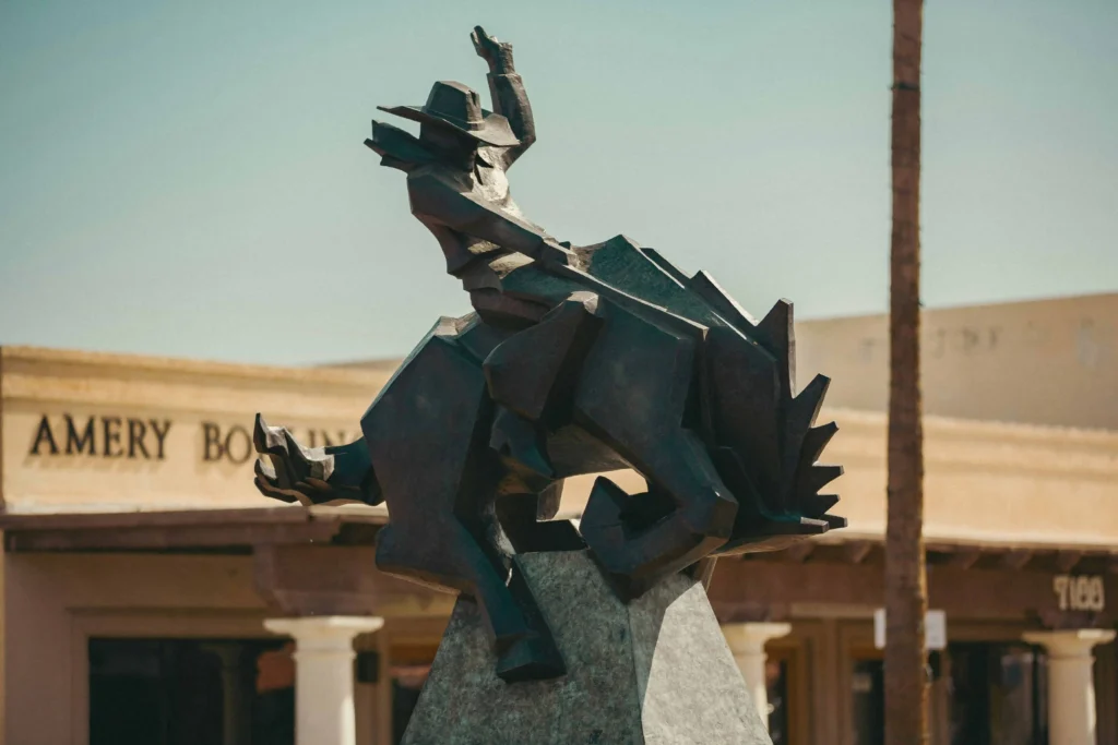 Best places to travel in the US in January: A bold bronze cowboy statue in Scottsdale, Arizona, symbolizing the Old West heritage under a clear blue winter sky."