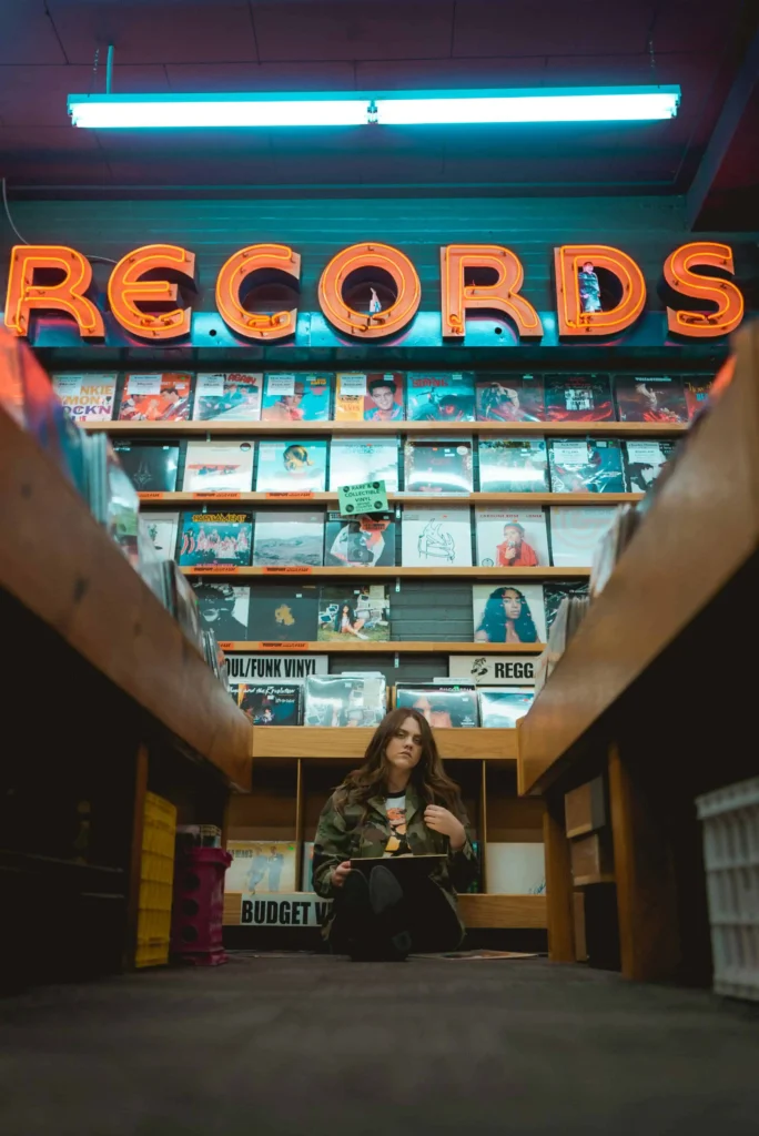 A cozy vintage record store in Boise, Idaho, with neon "Records" signage and shelves filled with vinyl albums