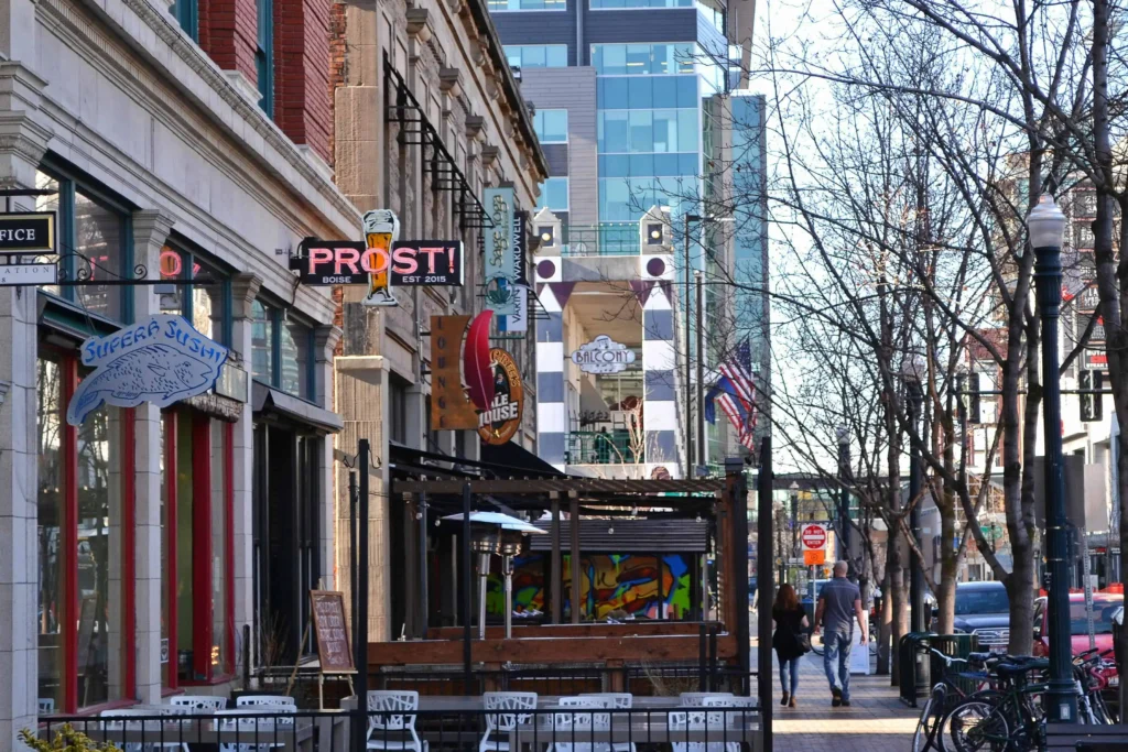 Downtown Boise street with restaurants, shops, and outdoor dining areas, showcasing a lively and inviting urban atmosphere.