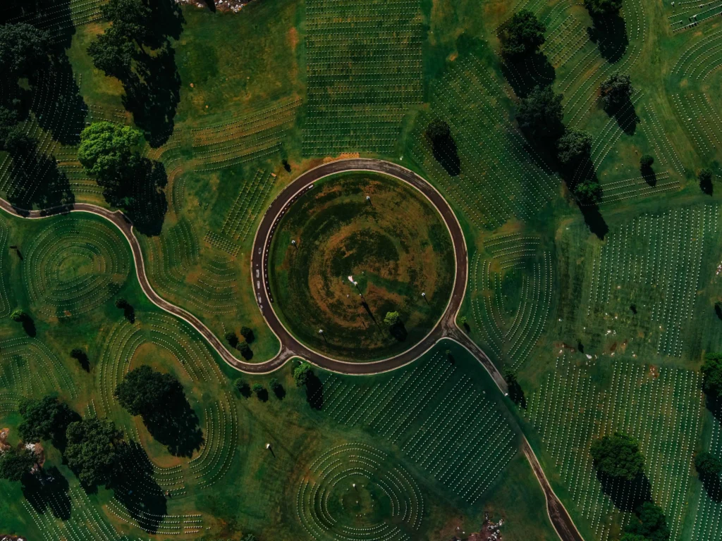 Things to do in Chattanooga: An aerial view of the Chattanooga National Cemetery featuring its circular pathways and meticulously arranged rows of grave markers amidst lush greenery.