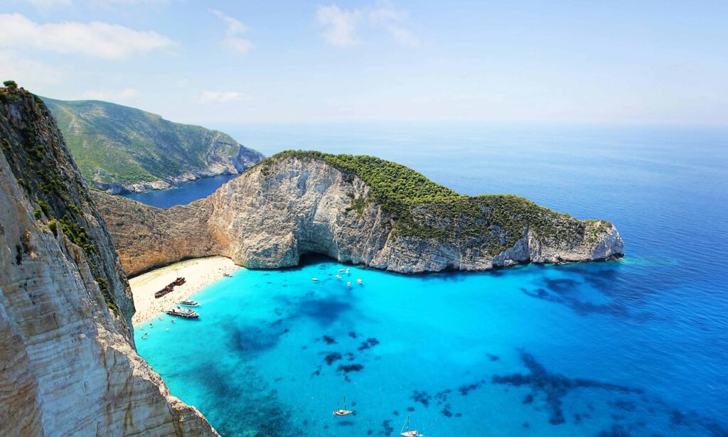 Aerial view of Navagio Beach in Zakynthos with the iconic shipwreck, a breathtaking spot for honeymooners.