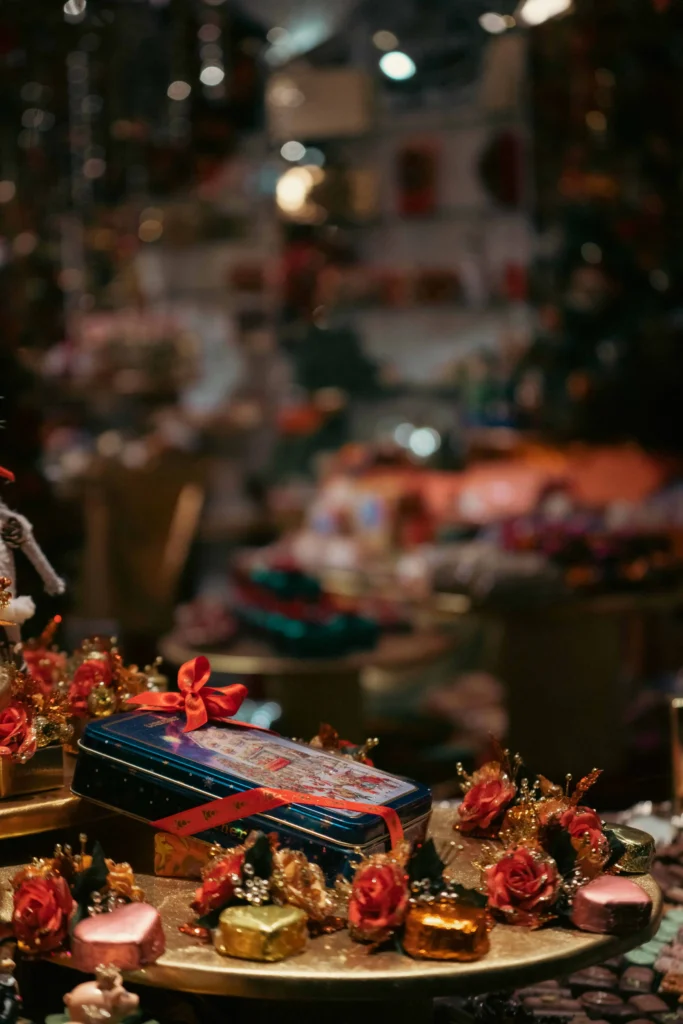 A close-up view of beautifully wrapped Christmas gifts and decorative ornaments on display at a festive market stall.