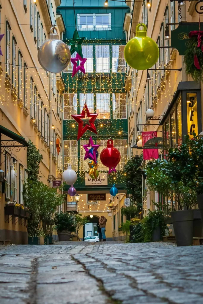 A beautifully decorated European alley with hanging stars, ornaments, and string lights, creating a cozy and festive atmosphere.