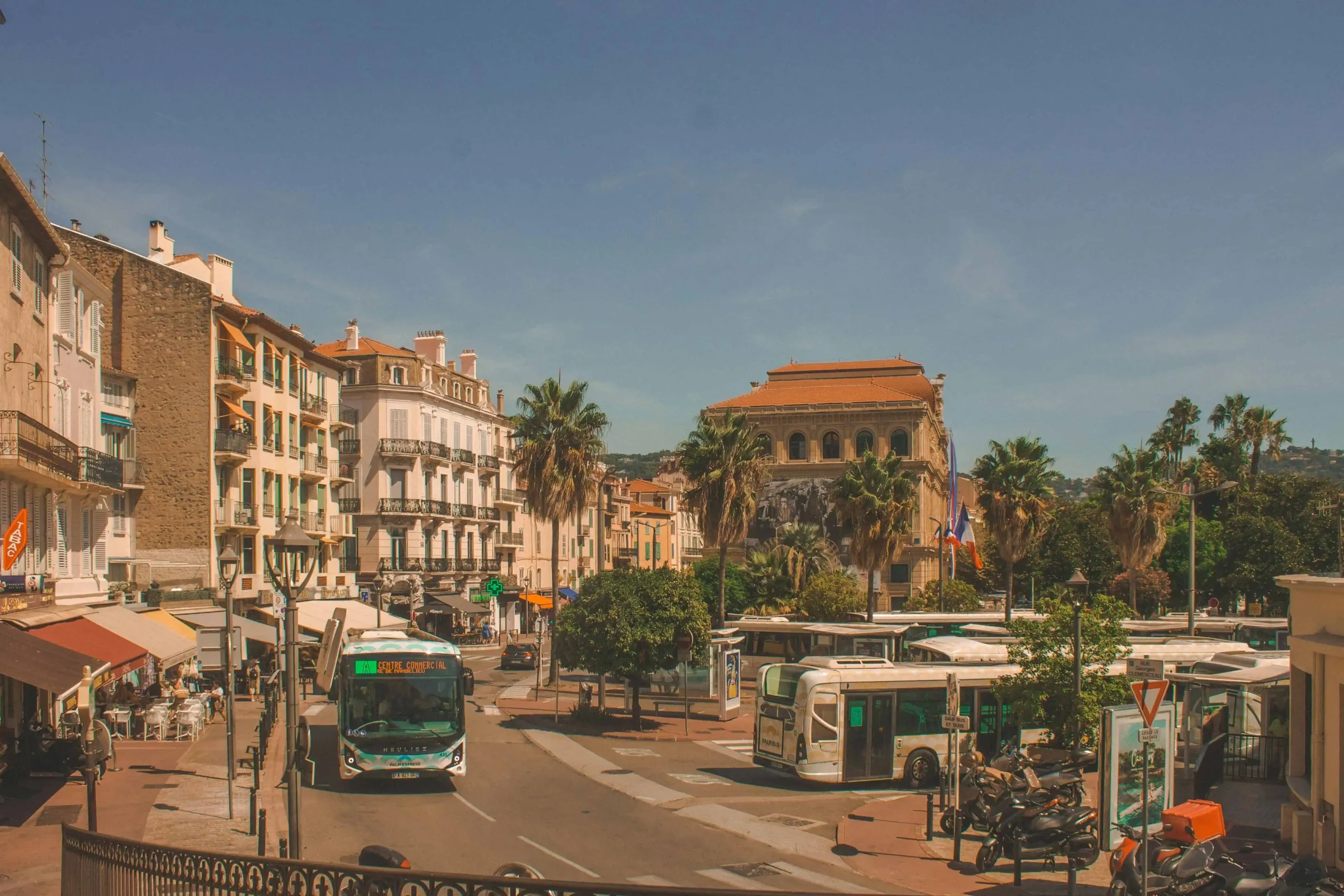 A bustling street in Cannes with picturesque Mediterranean-style buildings and a vibrant atmosphere, characteristic of the South of France