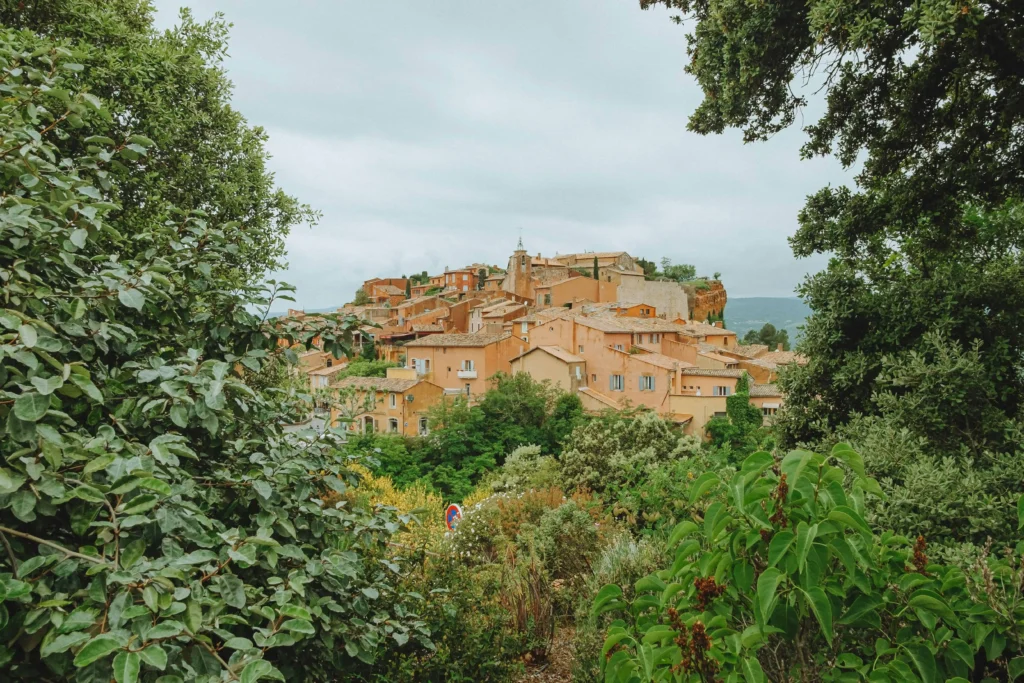 A charming hilltop village in Provence surrounded by green trees and countryside in France