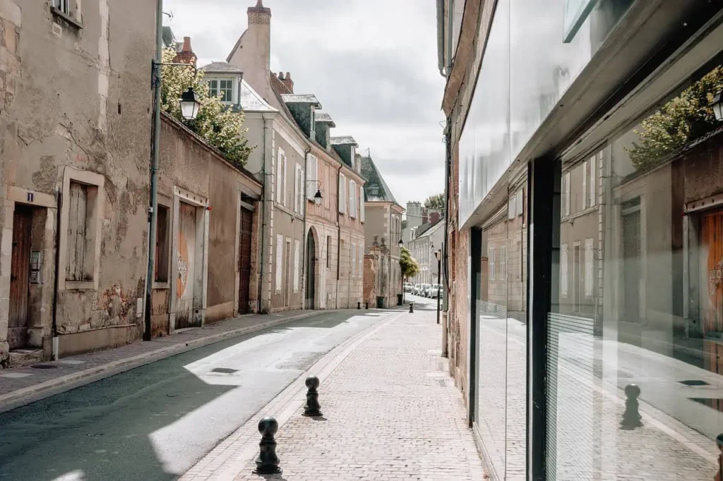 A quiet rustic street in a historic town, lined with vintage-style buildings.