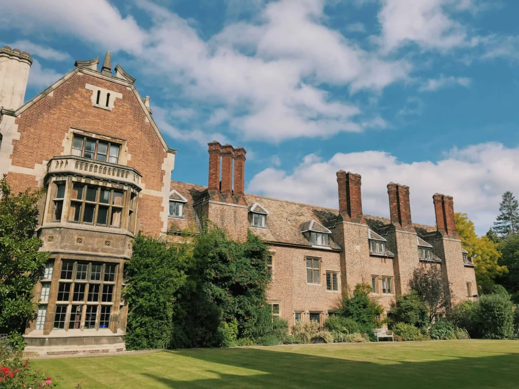 Stunning historic architecture in Cambridge, surrounded by lush greenery and a vibrant blue sky.