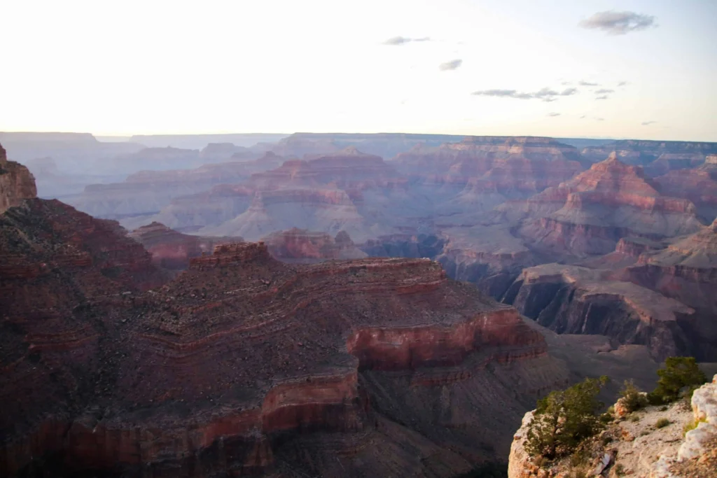 The Grand Canyon shrouded in soft morning light with deep shadows and rugged cliffs