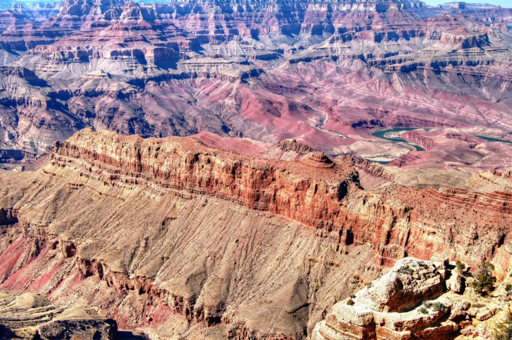 Aerial view of the Grand Canyon with vibrant red rock layers and the Colorado River