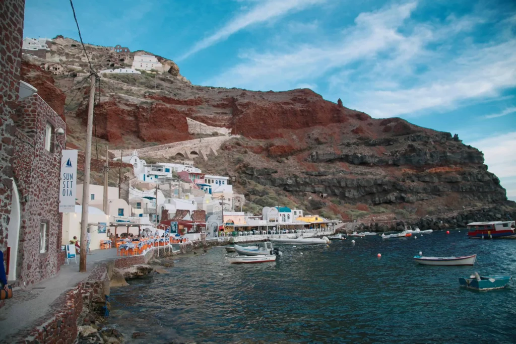 Vibrant tavernas and fishing boats in Ammoudi Bay at the foot of Oia, Santorini, offering a charming seaside experience. (Keyphrase: Santorini Greece Honeymoon)