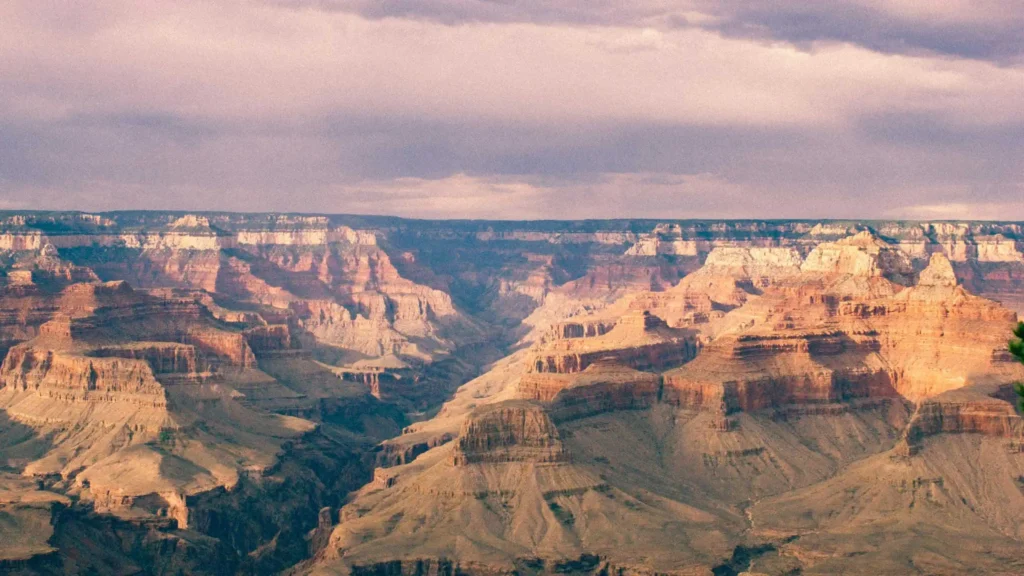 Grand Canyon's dramatic rock formations bathed in golden sunset hues