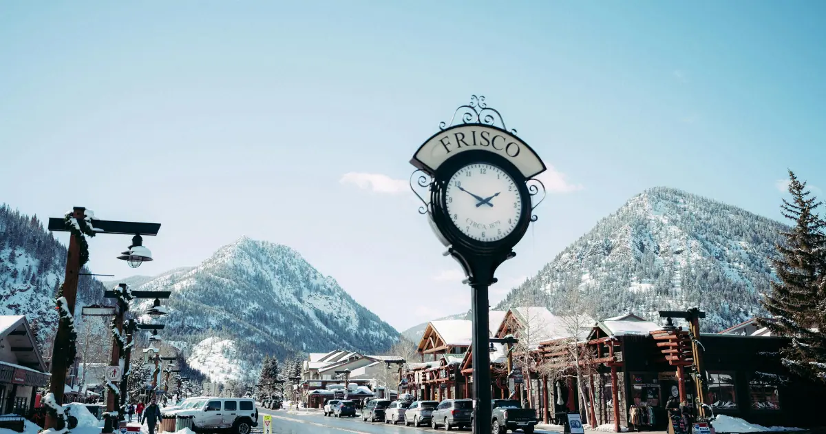 things to do in frisco – a classic clock tower with snowy mountain peaks in the background