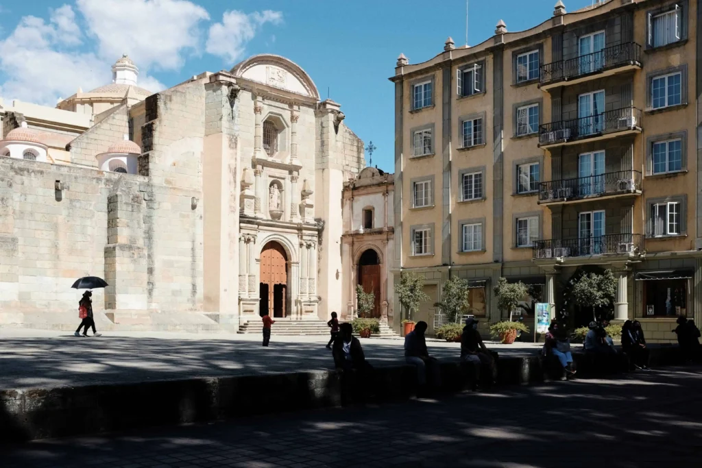 A view of Oaxaca’s colonial plaza featuring a historic church and charming surrounding buildings.