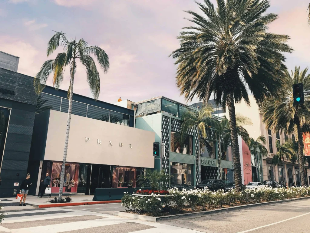 Rodeo Drive luxury shopping district with Prada and Gucci storefronts.