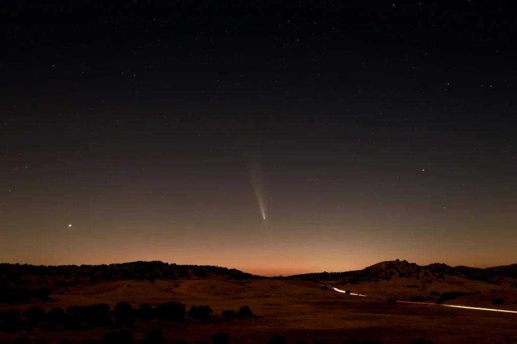 A breathtaking night sky in Julian CA, with a comet streaking across the horizon.