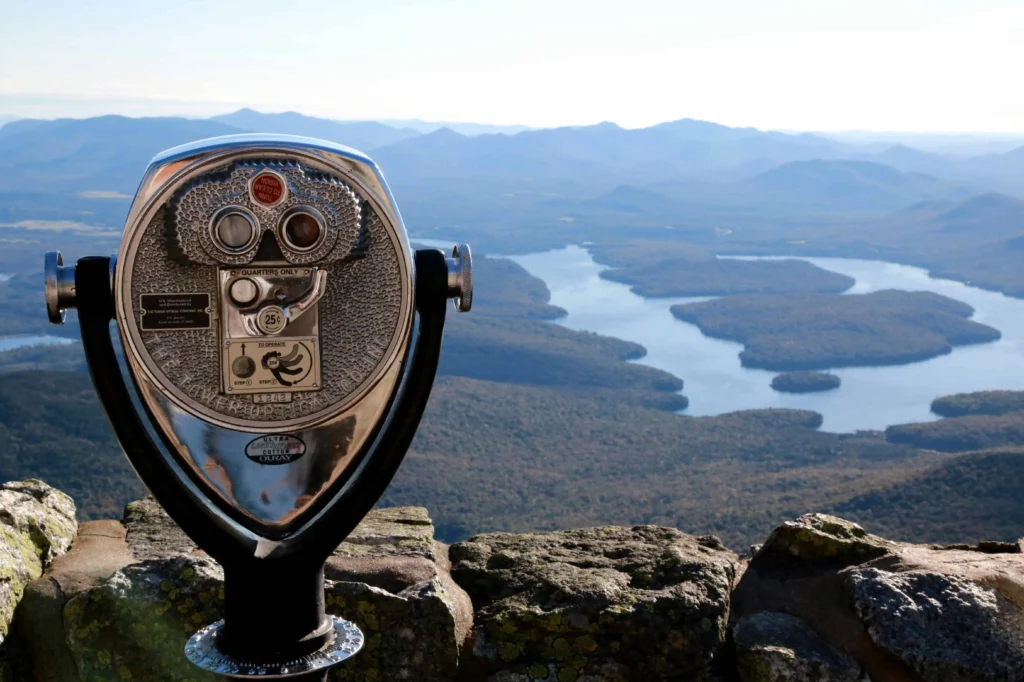 View of Lake Placid and surrounding mountains through coin-operated binoculars.