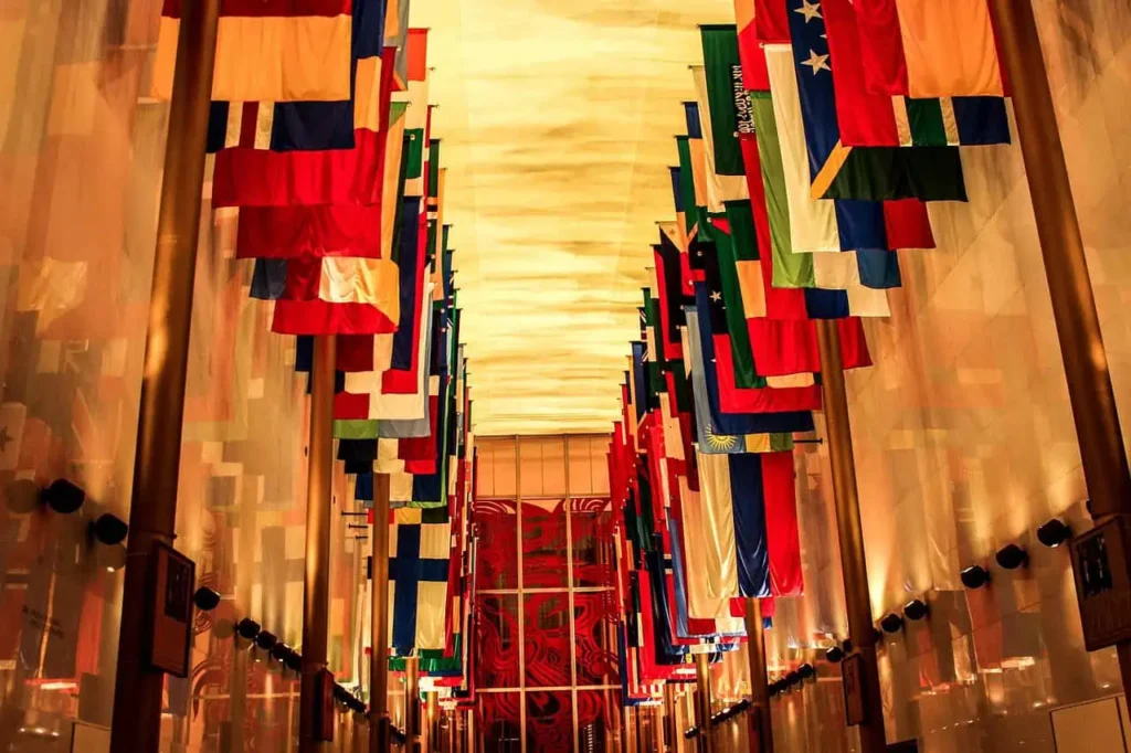 Interior view of the Hall of Nations with flags representing countries from around the world