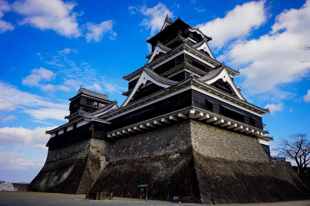 Fukuoka Castle surrounded by lush greenery and blue skies