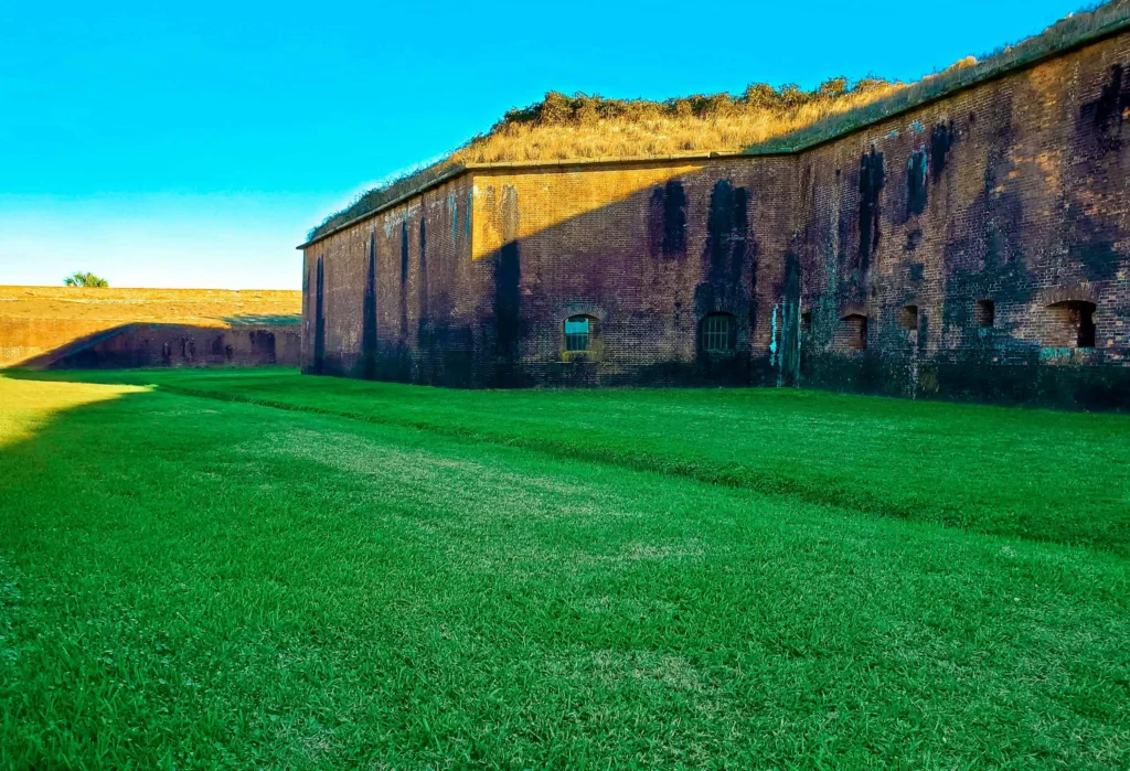 The historic brick walls of Fort Gaines, surrounded by green grass in Dauphin Island, Alabama.