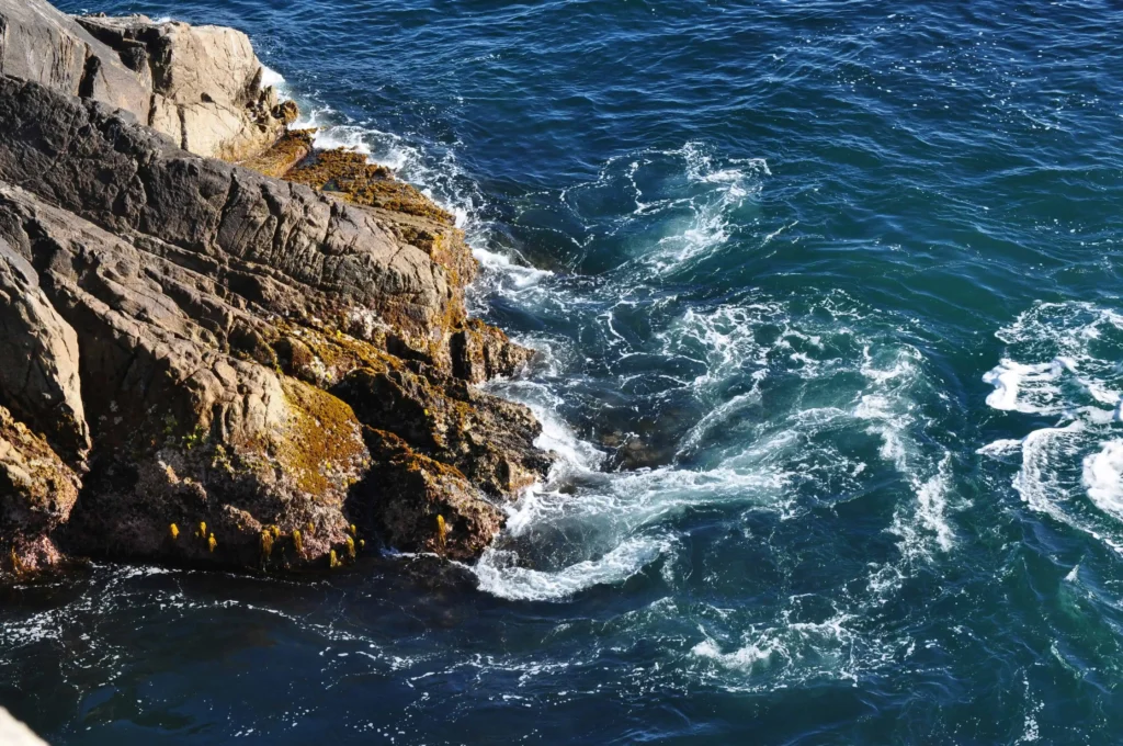 Powerful ocean waves crashing against rocky shores.