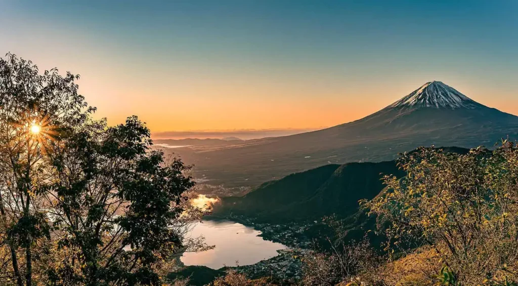 Mount Fuji with a glowing sunrise and a sea of clouds