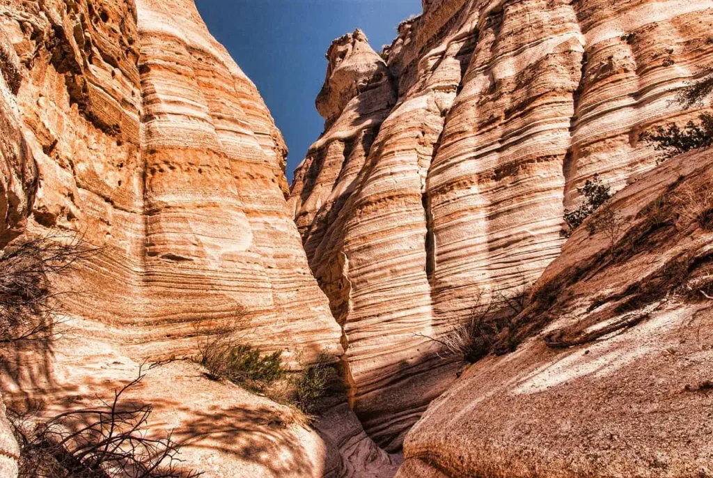 Sunlit slot canyon with stunning layered rock formations near Santa Fe.