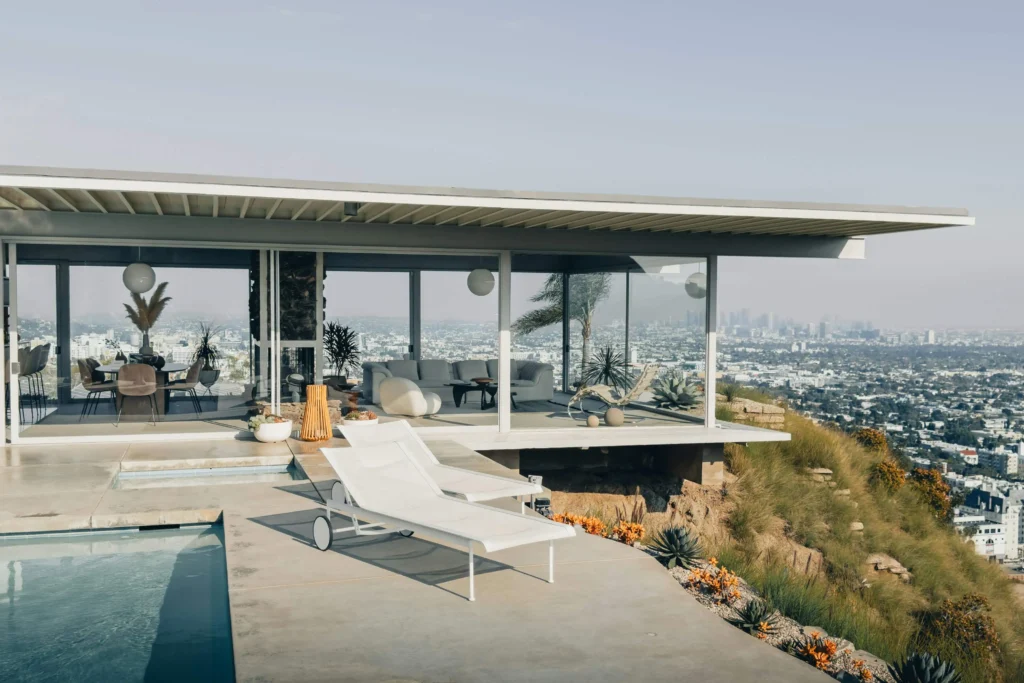 A luxury modern home with a pool overlooking the Los Angeles cityscape.