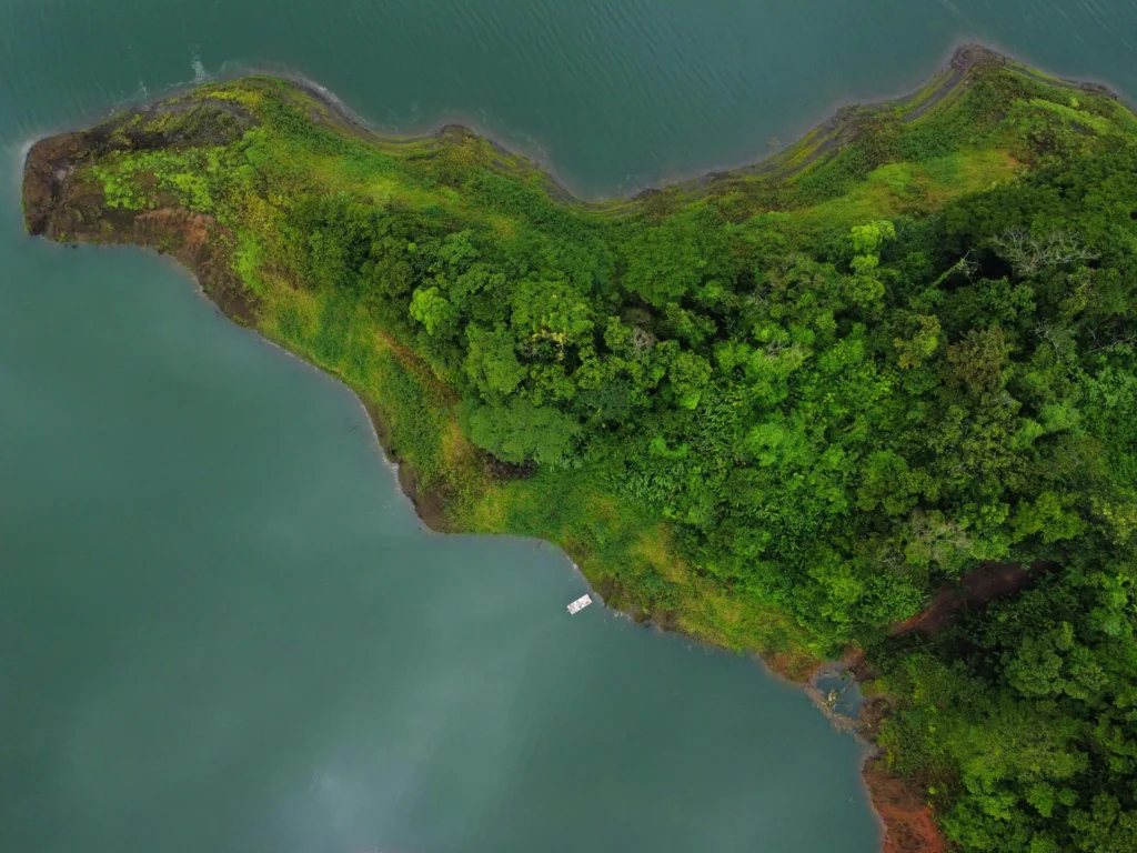 A scenic aerial view of Lake Arenal with lush greenery and tranquil blue waters in Costa Rica.