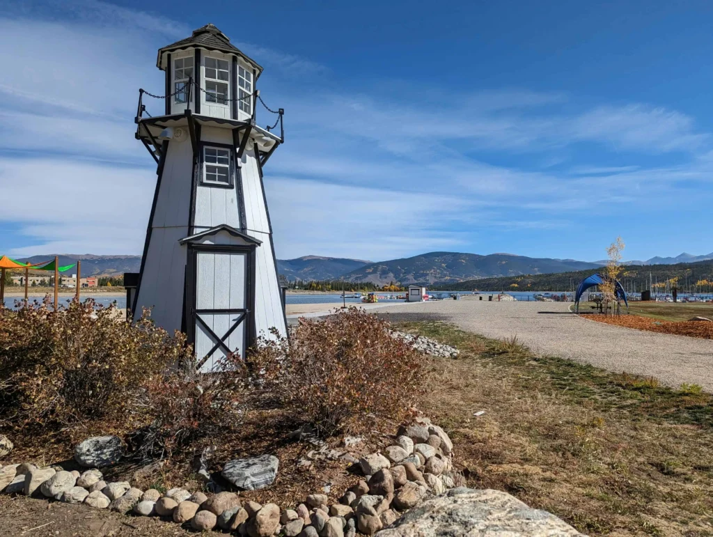 things to do in frisco – a small, lighthouse-like structure by the lake under a bright blue sky