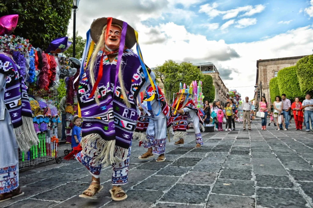 Colorful dancers performing at a traditional Mexican festival in Mexico City.