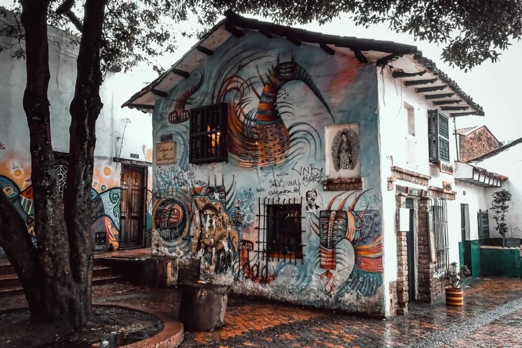 Vibrant street art on a colonial-style building in Bogota's La Candelaria neighborhood."