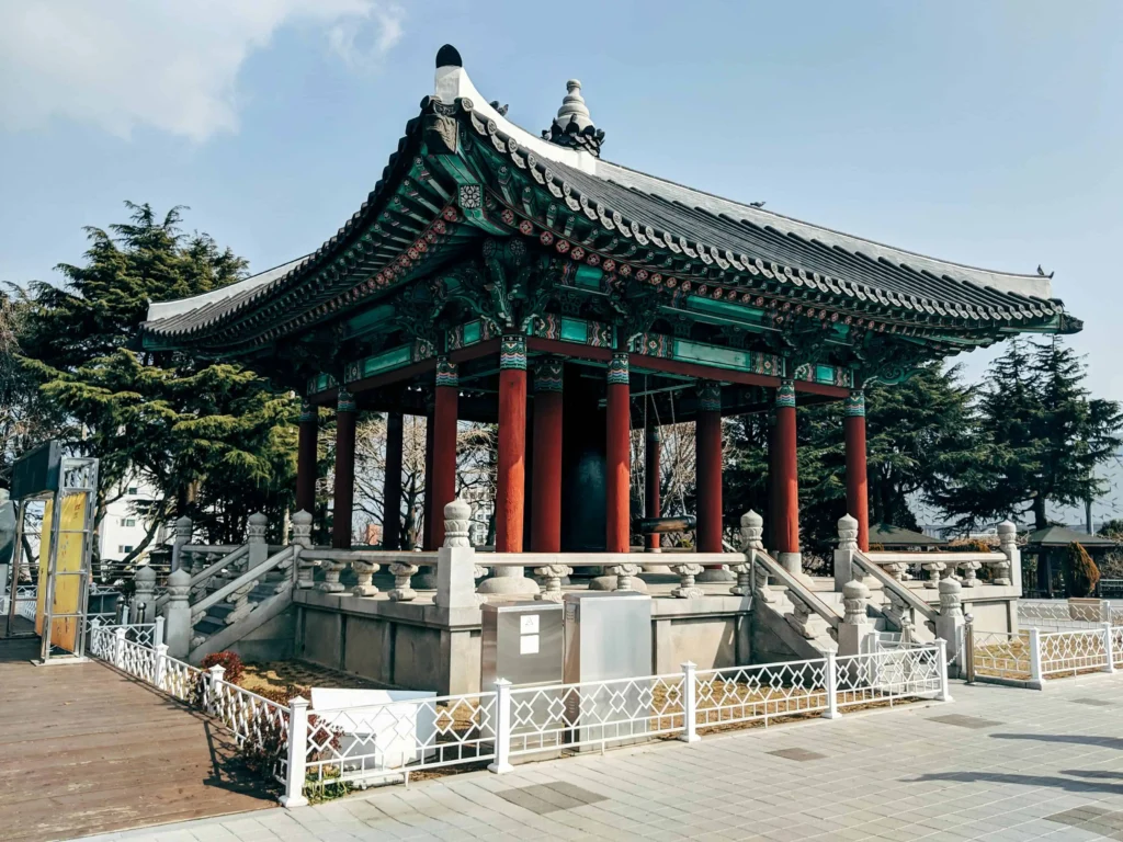 Traditional Korean pavilion surrounded by greenery in Busan.