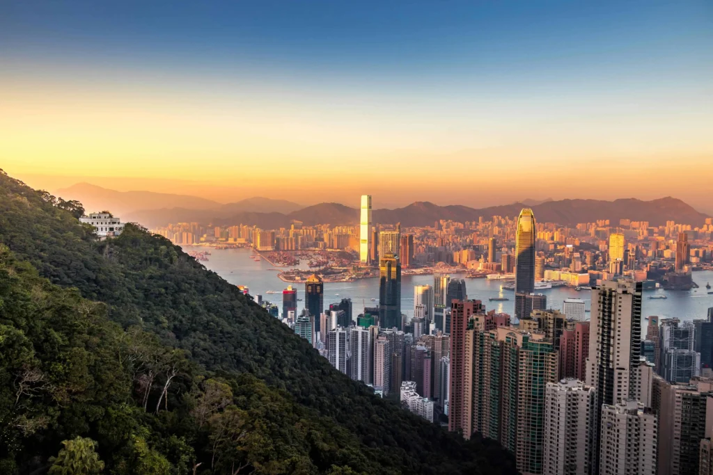 Daytime view of the iconic Hong Kong skyline featuring modern skyscrapers and Victoria Harbour