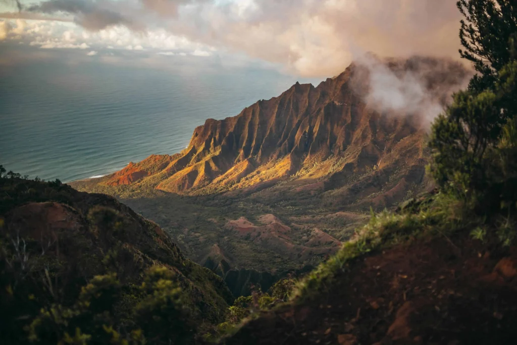 The dramatic green cliffs of Kauai meet the Pacific Ocean, creating an unforgettable landscape.