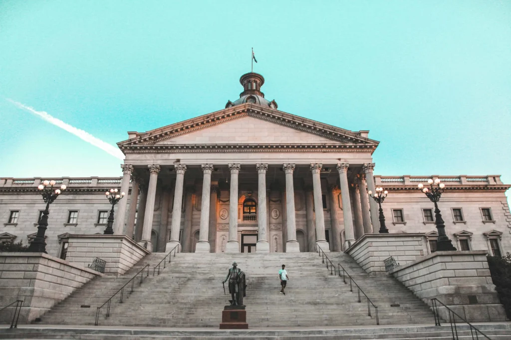 Front view of a historic government building in Charleston with stairs and pillars.