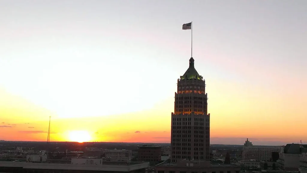 Romantic sunset view of a San Antonio skyscraper, perfect for couples exploring the city.