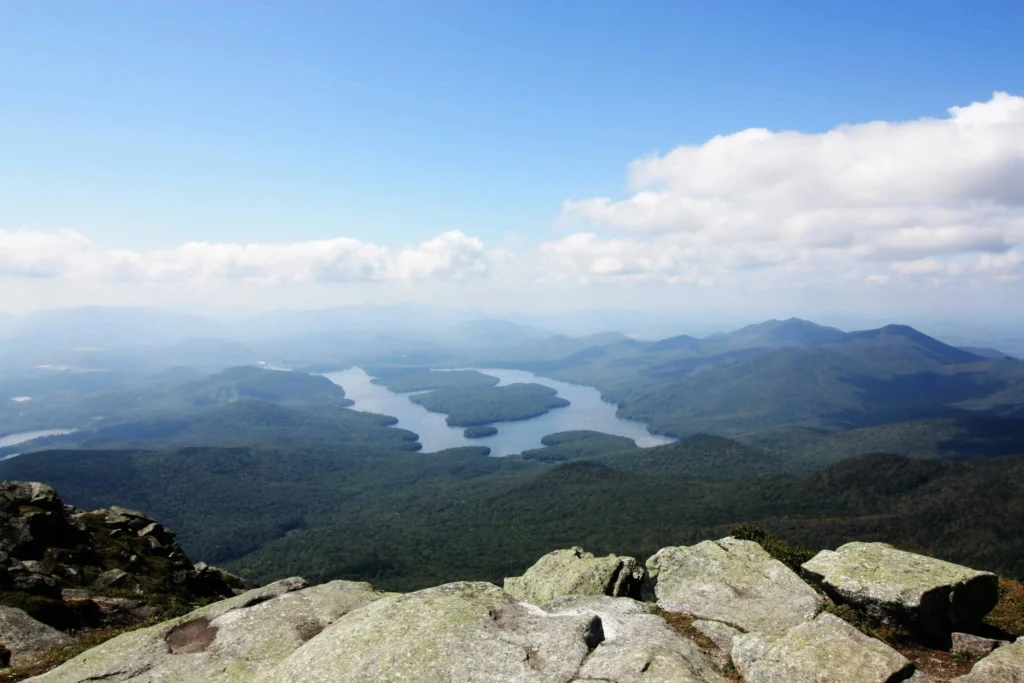 Aerial perspective of Lake Placid’s pristine waterways surrounded by lush greenery.