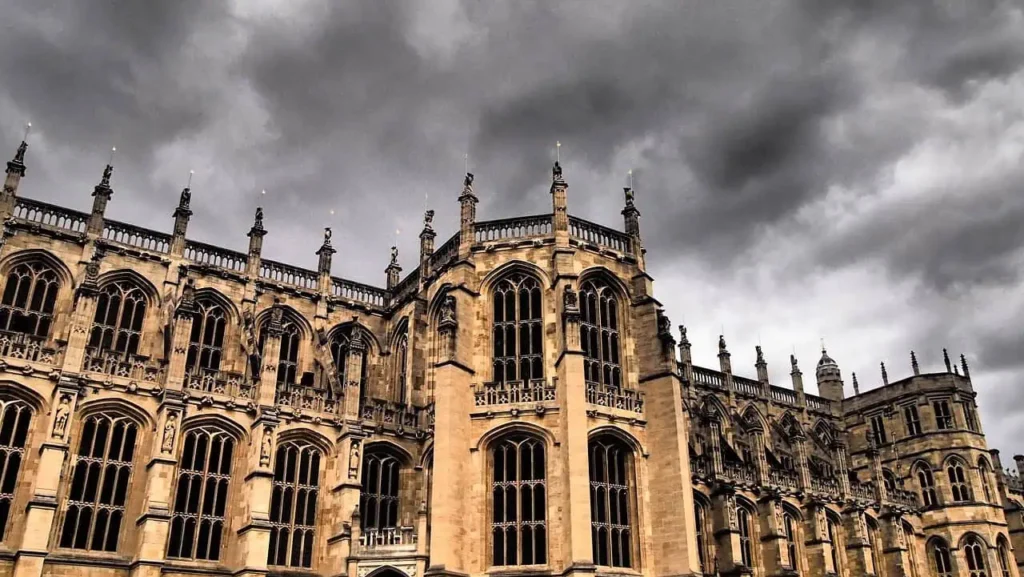 The intricate Gothic architecture of St. George’s Chapel in Windsor under dramatic skies.