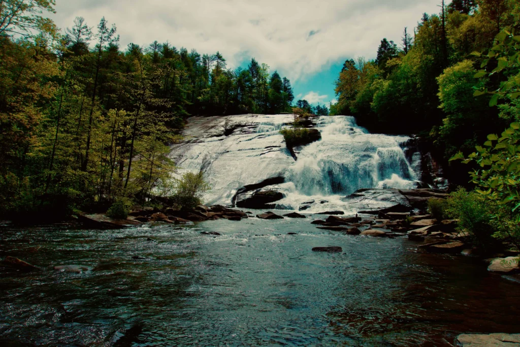 Majestic waterfall flowing through a forest in Upstate New York.