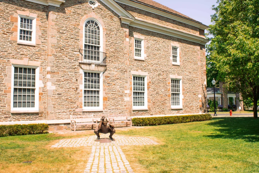 A historic stone building with a unique sculpture in Upstate New York.
